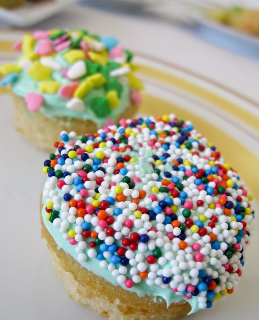 Let party guests decorate their own mini cupcakes. Using the recipe from our party guide, we baked these in mini muffin pans. Provide a bowl of frosting and plenty of sprinkles. Tipping the cupcake upside down, swirl in a bowl of frosting. Remove and dip in a bowl of sprinkles.