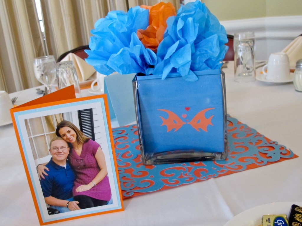 we made 'fish bowls' for each table using blue paper and tiny fish cut-outs in glass vases. Tissue paper flowers were put inside, and the pictures from the couples engagement session were displayed on tables around the room.