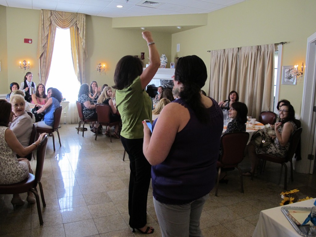 One of my favorite shower games is a 'purse scavenger hunt.' We divided the shower guests into groups (by table) and told everyone to take out their purse or handbag. Give the host a list of random items you might find in a purse or handbag. As items are called, the first table to bring up that item gets a point. 