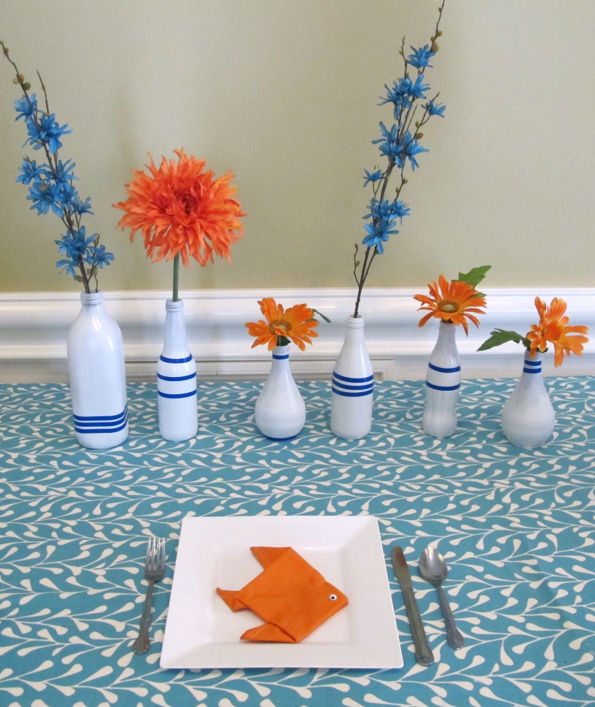 This party was a lot of fun to decorate for. The groom’s favorite color is orange (go Texas!) and so we used orange and blue as the main colors. The shower was at a beautiful restaurant, so the only thing we did was the dessert table and the guest’s tables. We collected glass vases and jars and spray painted them all white, then added blue artists tape to give them some fun lines. Orange and blue flowers were picked up at a local craft store and added to the vases, which sat behind the dessert table.