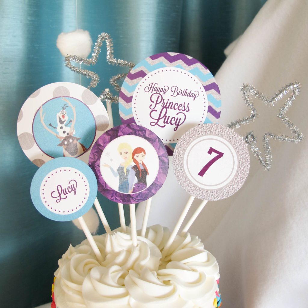 Frozen Birthday Cake: We purchased a small cake from the grocery store and decorated it with these Customized Frozen Cake toppers, adding a few silver pipe cleaner shapes for some sparkle. 