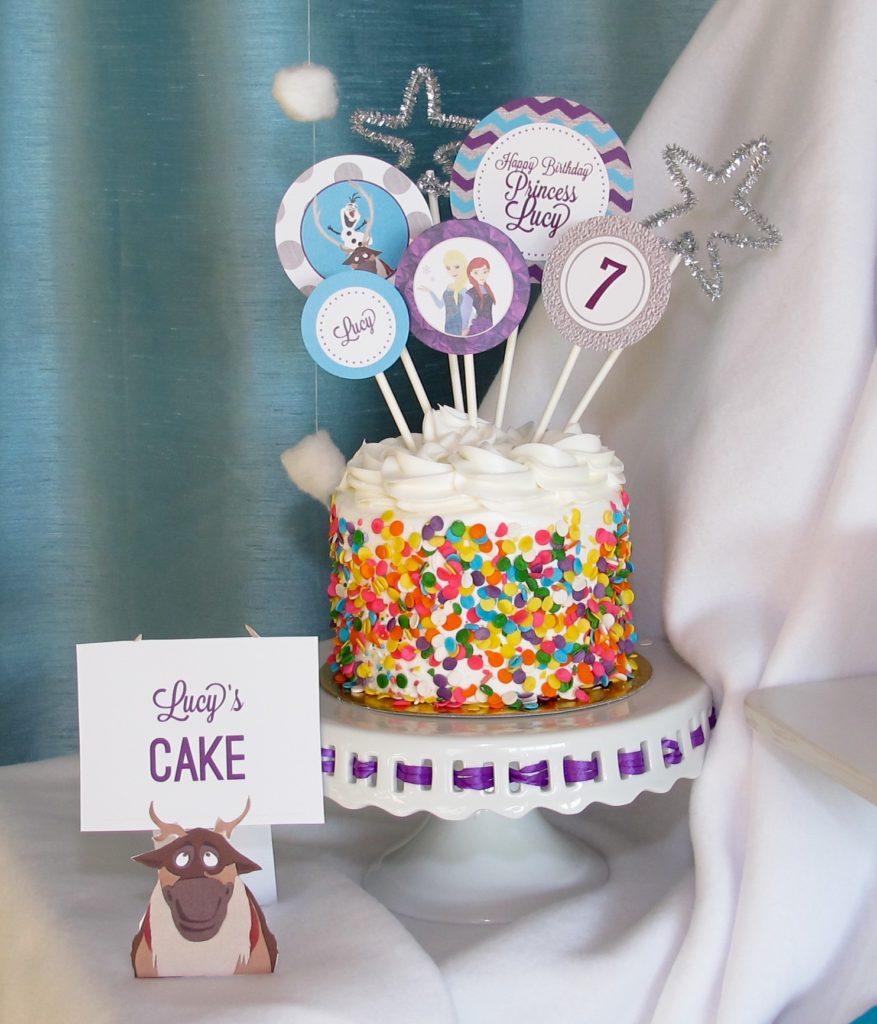 Frozen Birthday Cake: We purchased a small cake from the grocery store and decorated it with these Customized Frozen Cake toppers, adding a few silver pipe cleaner shapes for some sparkle. 