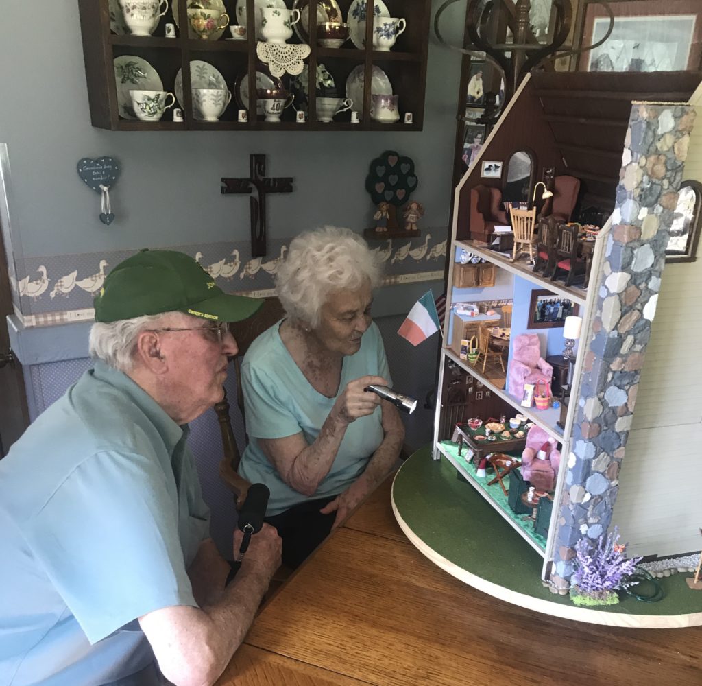 Grandma and Grandpa looking at heirloom dollhouse for the first time