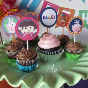 Dora the Explorer Cupcakes | Cupcakes are the perfect addition to any party. We made chocolate cupcakes with chocolate frosting, and used Dora the Explorer cupcake toppers to add some fun and color to the table.