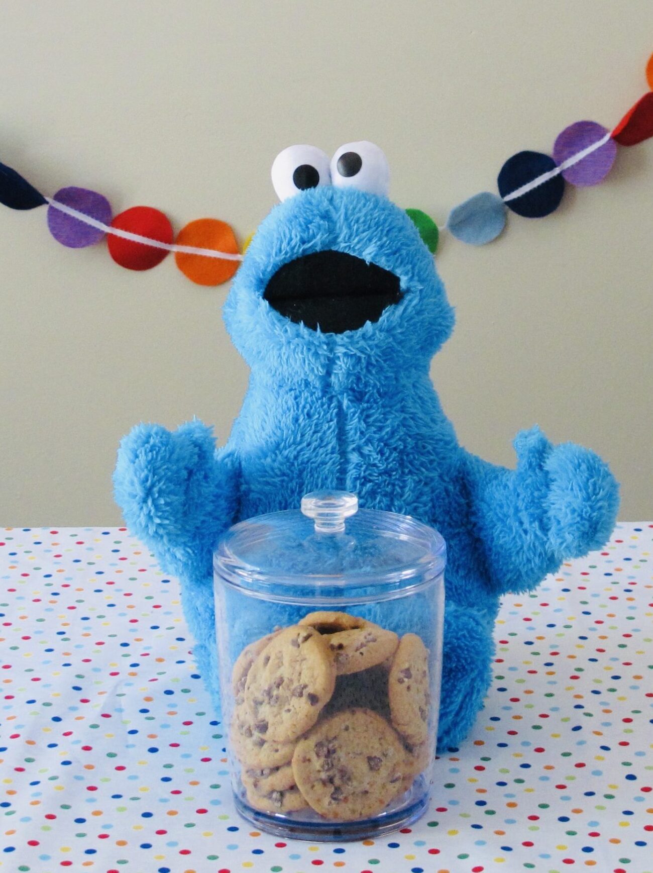 Cookie Monster’s Cookies displayed in a clear cookie jar with Cookie Monster plush