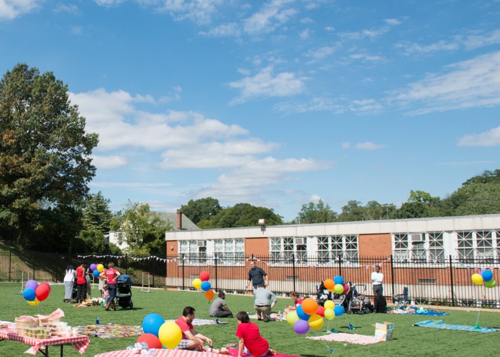 Church Neighborhood Grand Launch Picnic with picnic blankets and balloons. Yard games, chipotle, and cupcakes to celebrate grand opening.